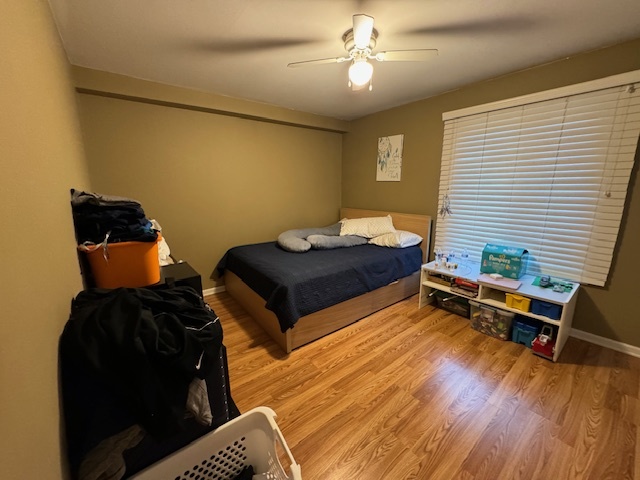 1802 Plum Grove Road, Unit 1D Rolling Meadows, IL 60008 - Photo 9 of 14 a bedroom with furniture and wooden floor