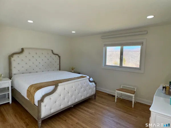 a bedroom with a bed and a chair