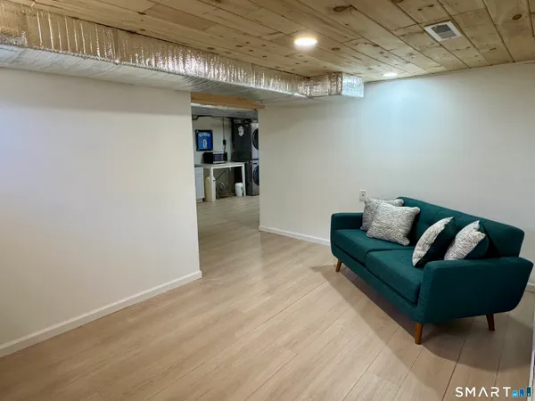 a living room with furniture and a book shelf