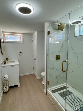 a bathroom with a shower and mirror