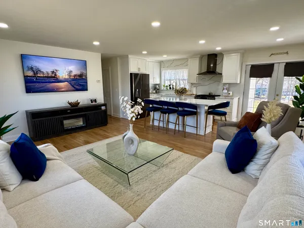 a living room with furniture kitchen view and a table