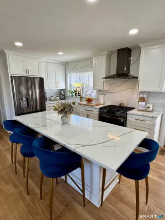 a kitchen with a dining table and chairs