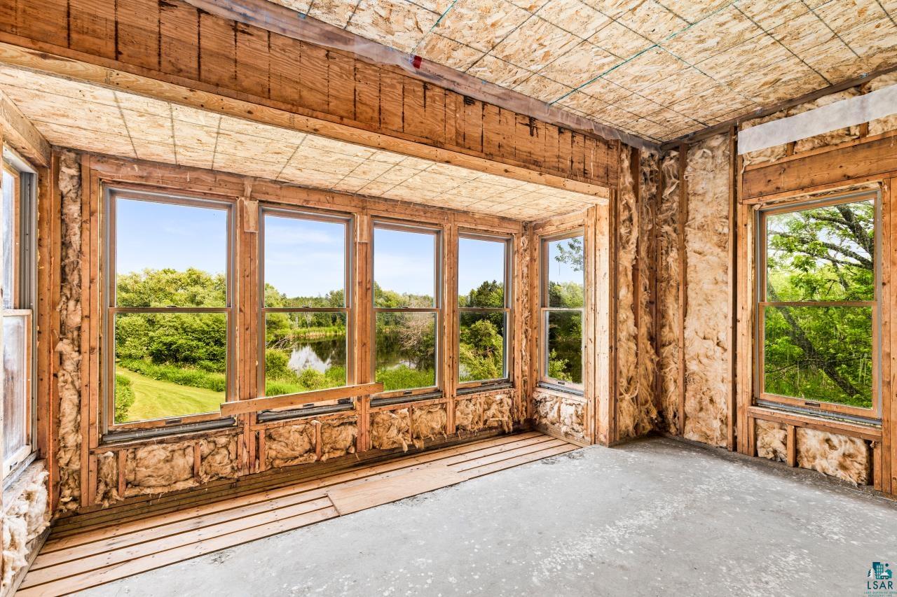 4800 Tower Road Moose Lake, MN 55767 - Photo 70 of 83 Bay window framing a verdant landscape with a pond