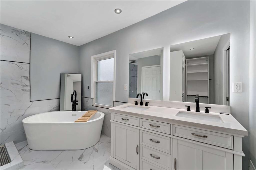 2002 Hampton Street Pittsburgh, PA 15218 - Photo 12 of 21 a bathroom with double vanity sinks a mirror and a bathtub