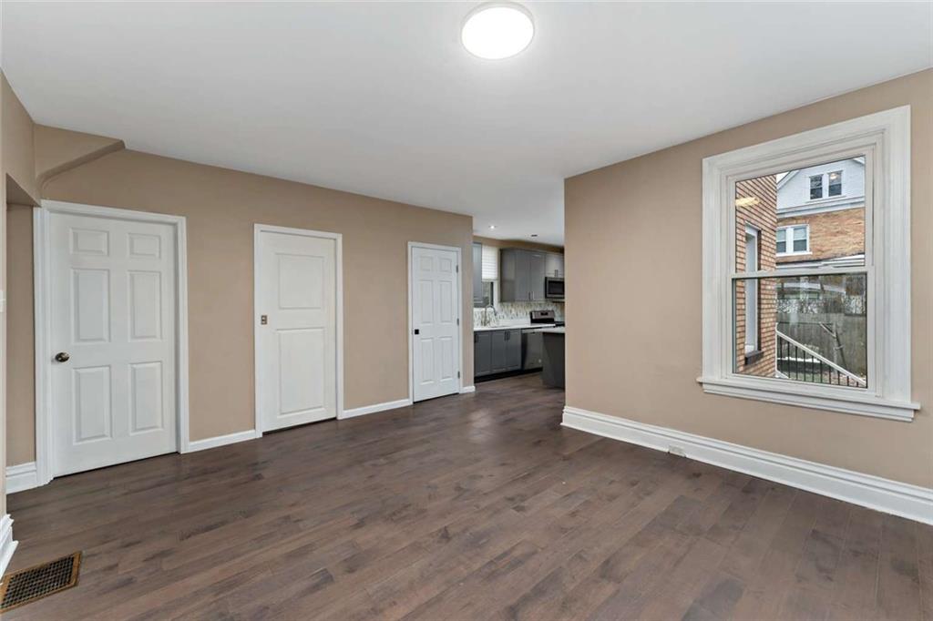 2002 Hampton Street Pittsburgh, PA 15218 - Photo 4 of 21 a view of a big room with wooden floor kitchen and windows