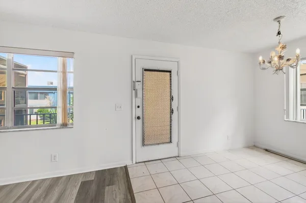 an empty room with windows and closet