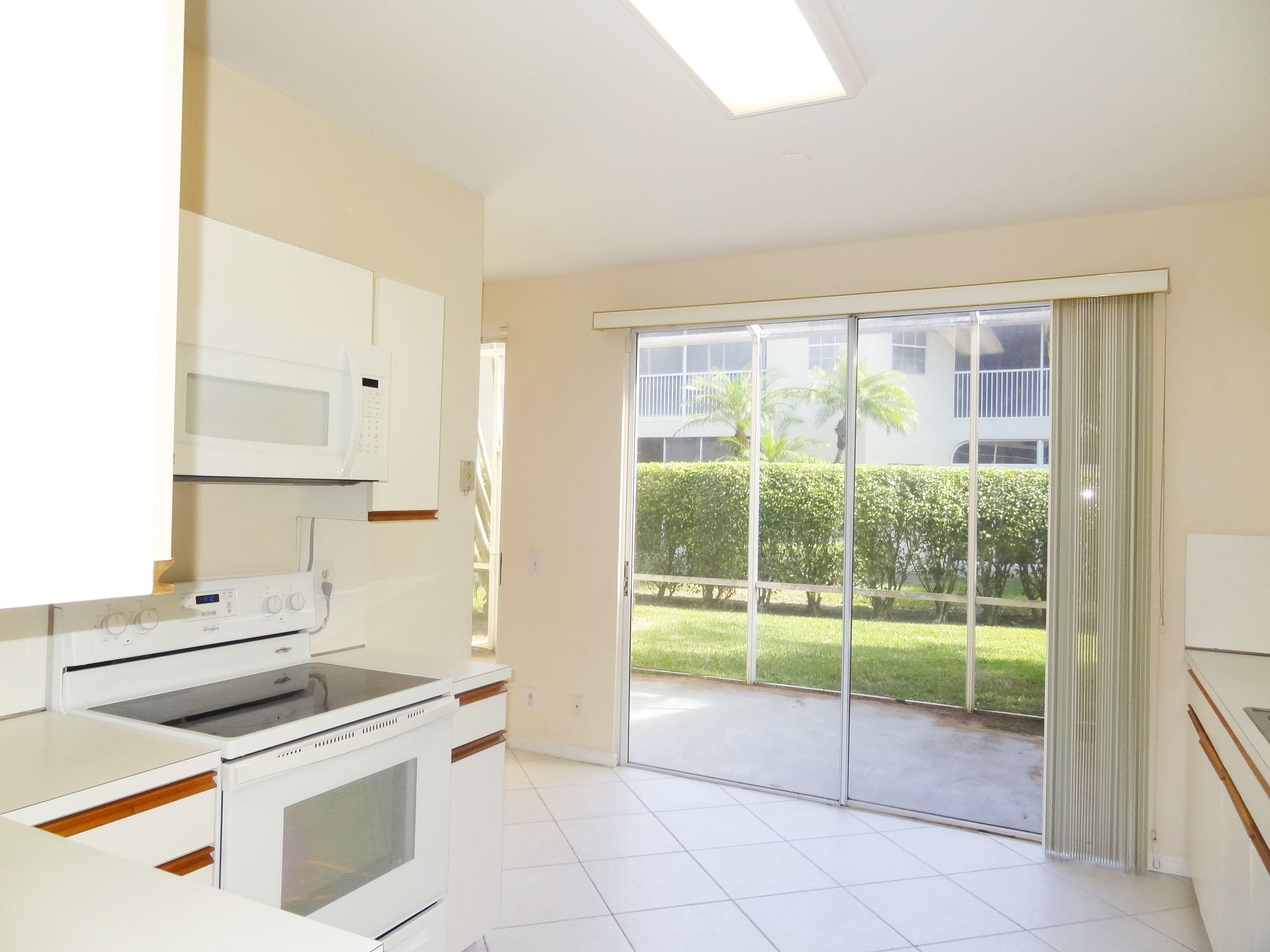 6704 Via Regina Boca Raton, FL 33433 - Photo 8 of 20 KITCHEN OPEN TO PATIO