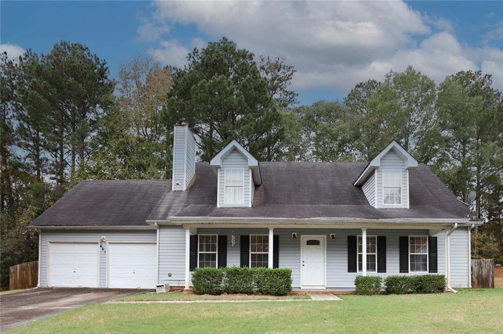 661 Michael Circle Monroe, GA 30655 - Photo 1 of 20 a front view of a house with a garden and trees