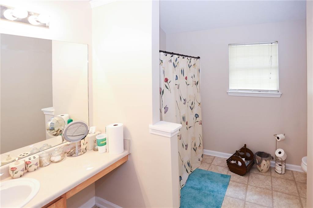 661 Michael Circle Monroe, GA 30655 - Photo 16 of 20 a bathroom with a sink toilet and shower