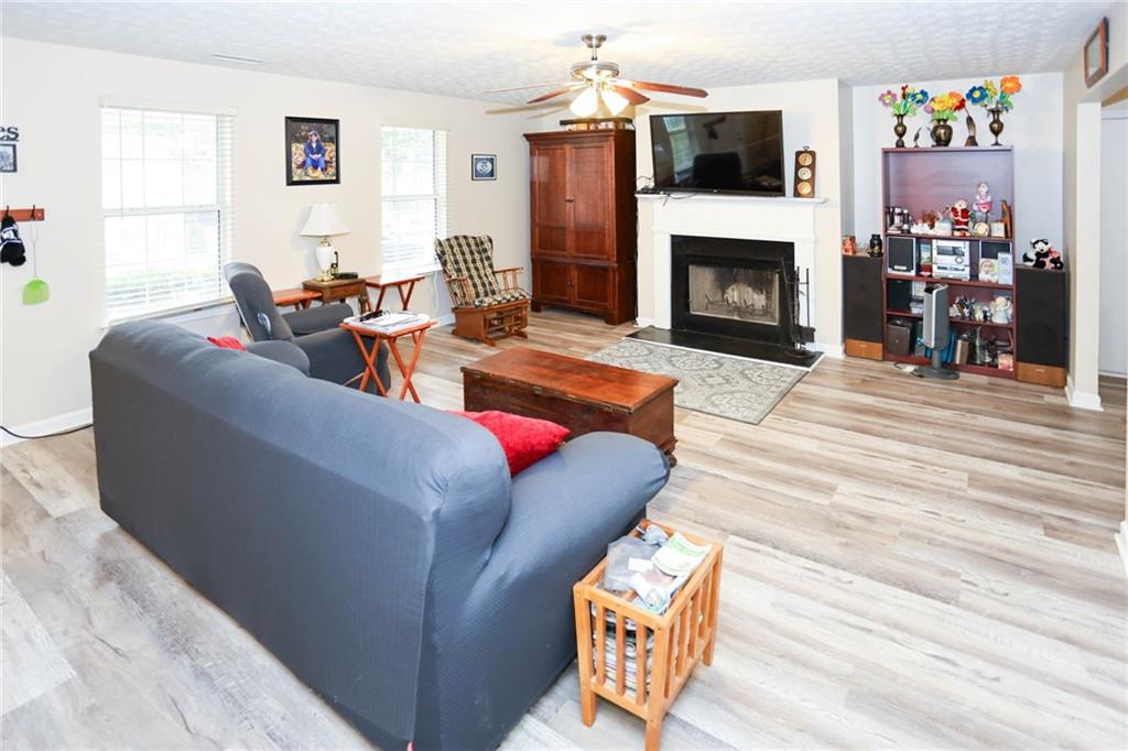 661 Michael Circle Monroe, GA 30655 - Photo 4 of 20 a living room with furniture a fireplace and a flat screen tv