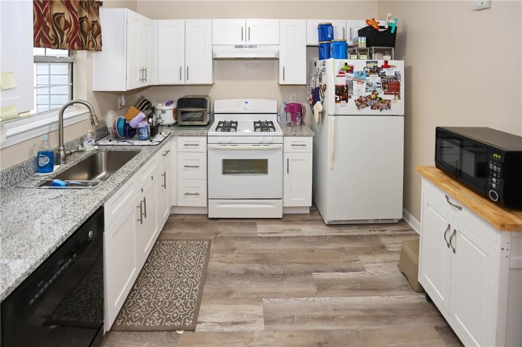 661 Michael Circle Monroe, GA 30655 - Photo 6 of 20 a kitchen with granite countertop white cabinets and white appliances