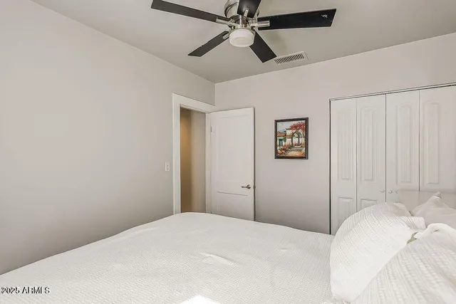 a bedroom with a bed and a window