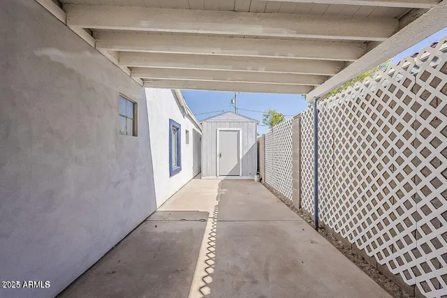 a room with painting on the wall and a potted plant