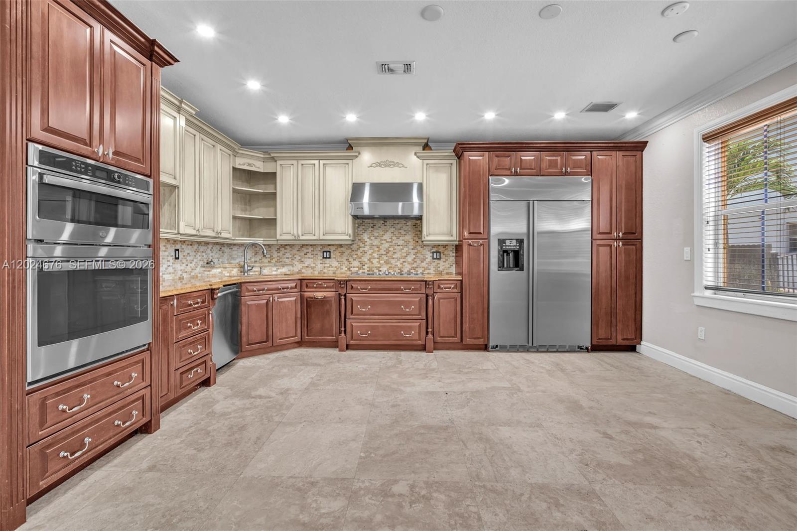 2155 Southwest 156th Court Miami, FL 33185 - Photo 22 of 57 a large kitchen with stainless steel appliances granite countertop a refrigerator and a stove top oven