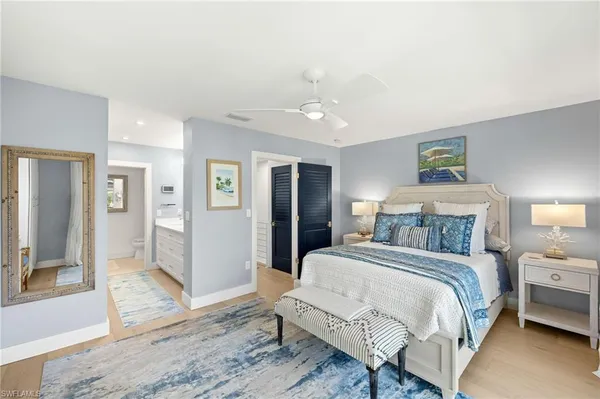 a spacious bedroom with a bed and a view of bathroom