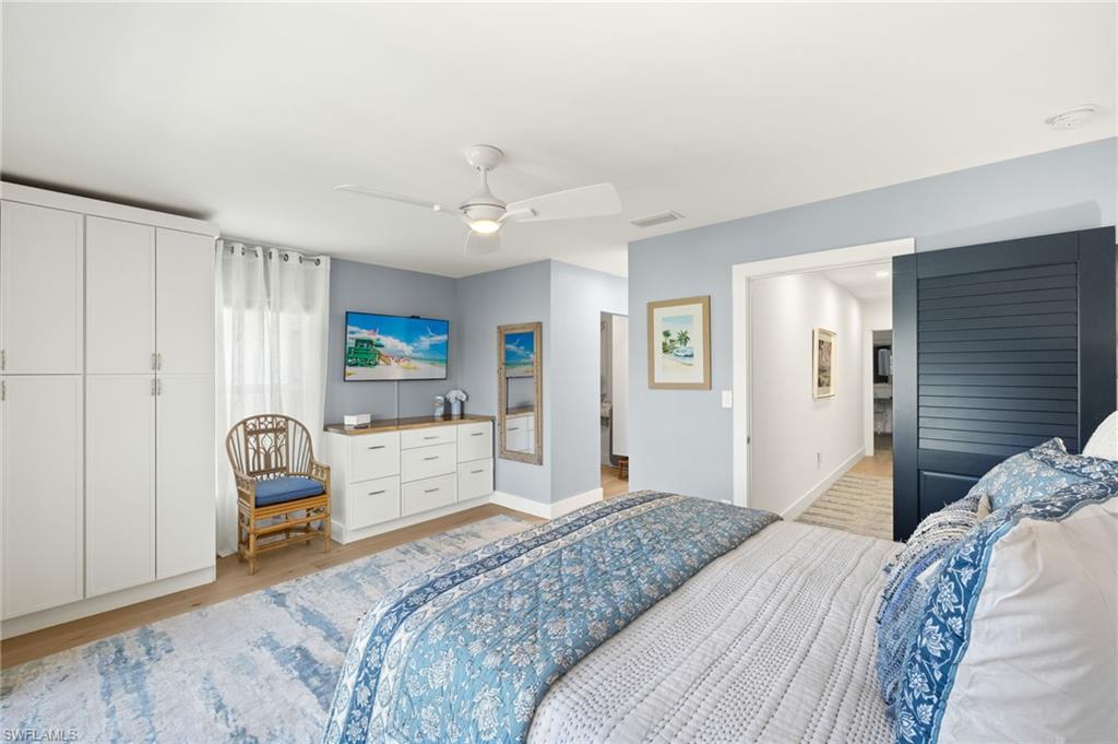 1060 6th Street South, Unit 1060 Naples, FL 34102 - Photo 16 of 26 a bedroom with a bed and a chair