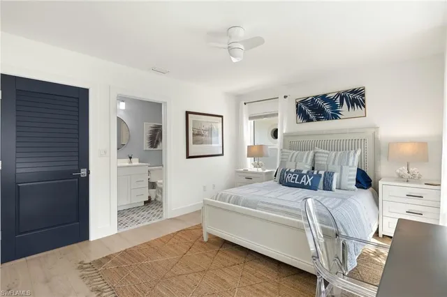 a bedroom with a bed a mirror and lamp