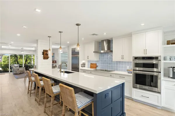 a kitchen with a table chairs sink and cabinets