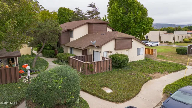 an aerial view of a house with garden space and street view