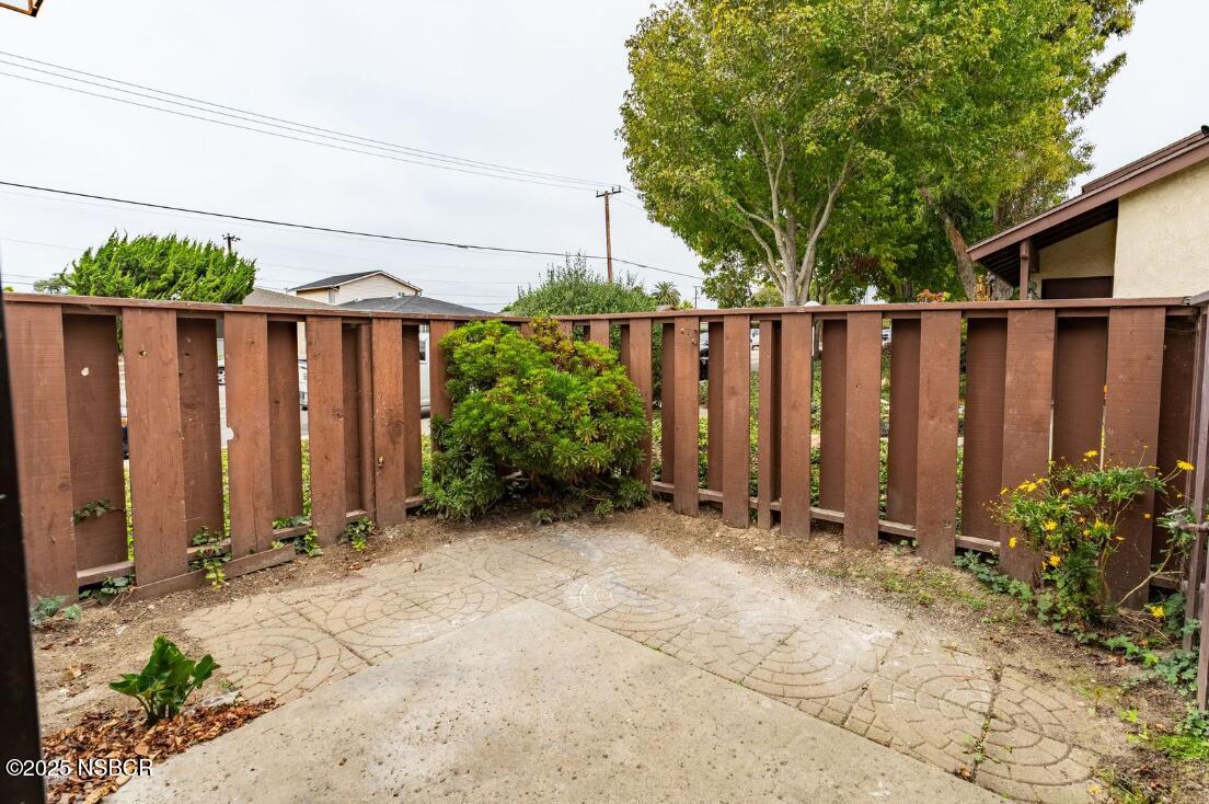 1200 East Walnut Avenue, Unit A Lompoc, CA 93436 - Photo 14 of 23 a backyard of a house with plants and wooden fence