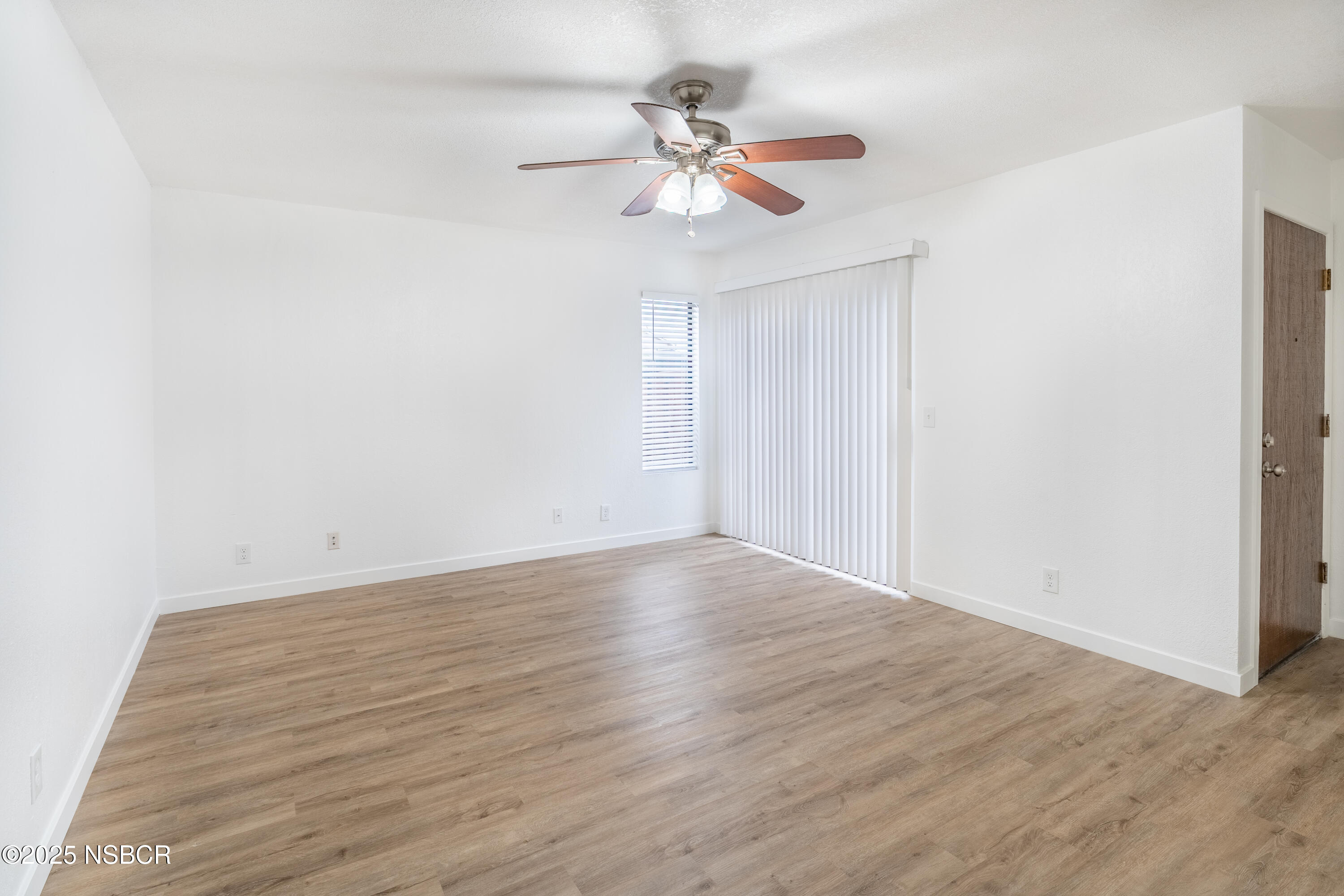 1200 East Walnut Avenue, Unit A Lompoc, CA 93436 - Photo 5 of 23 a view of an empty room with wooden floor