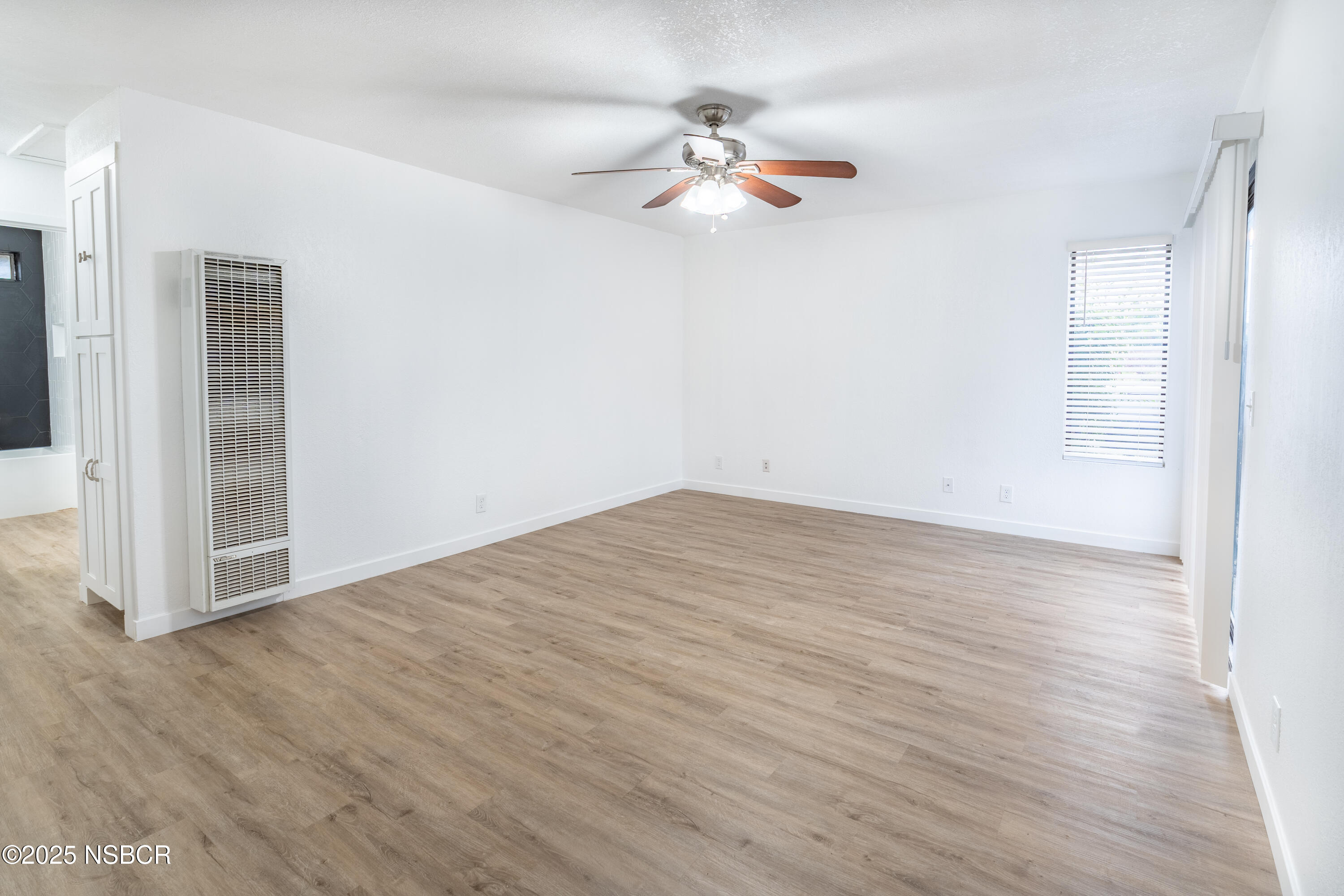 1200 East Walnut Avenue, Unit A Lompoc, CA 93436 - Photo 6 of 23 a view of a room with wooden floor and white walls