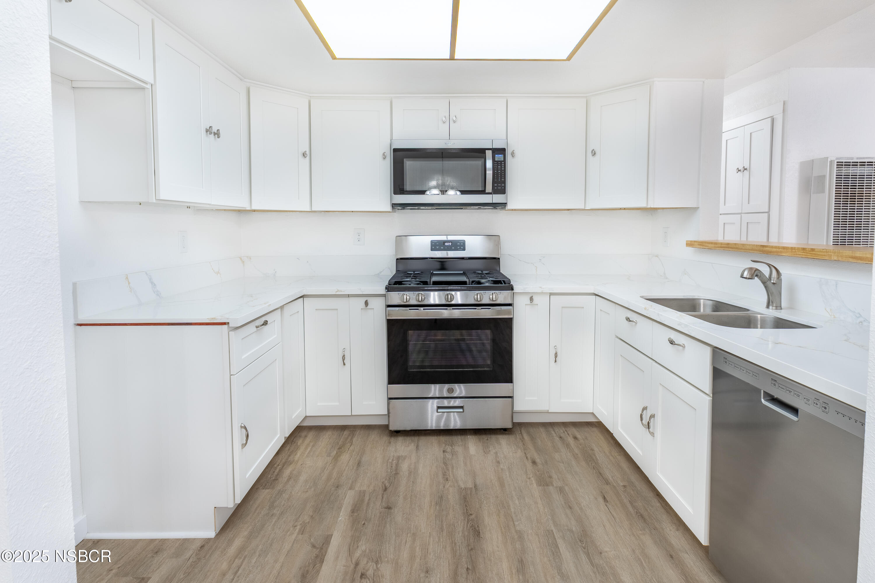 1200 East Walnut Avenue, Unit A Lompoc, CA 93436 - Photo 8 of 23 a kitchen with a stove a sink and a refrigerator