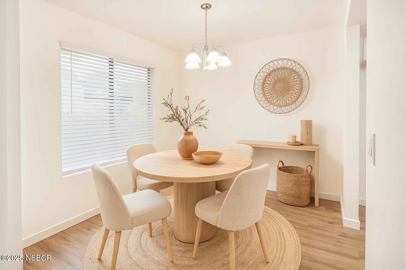 1200 East Walnut Avenue, Unit A Lompoc, CA 93436 - Photo 10 of 23 a dining room with wooden floor and a chandelier