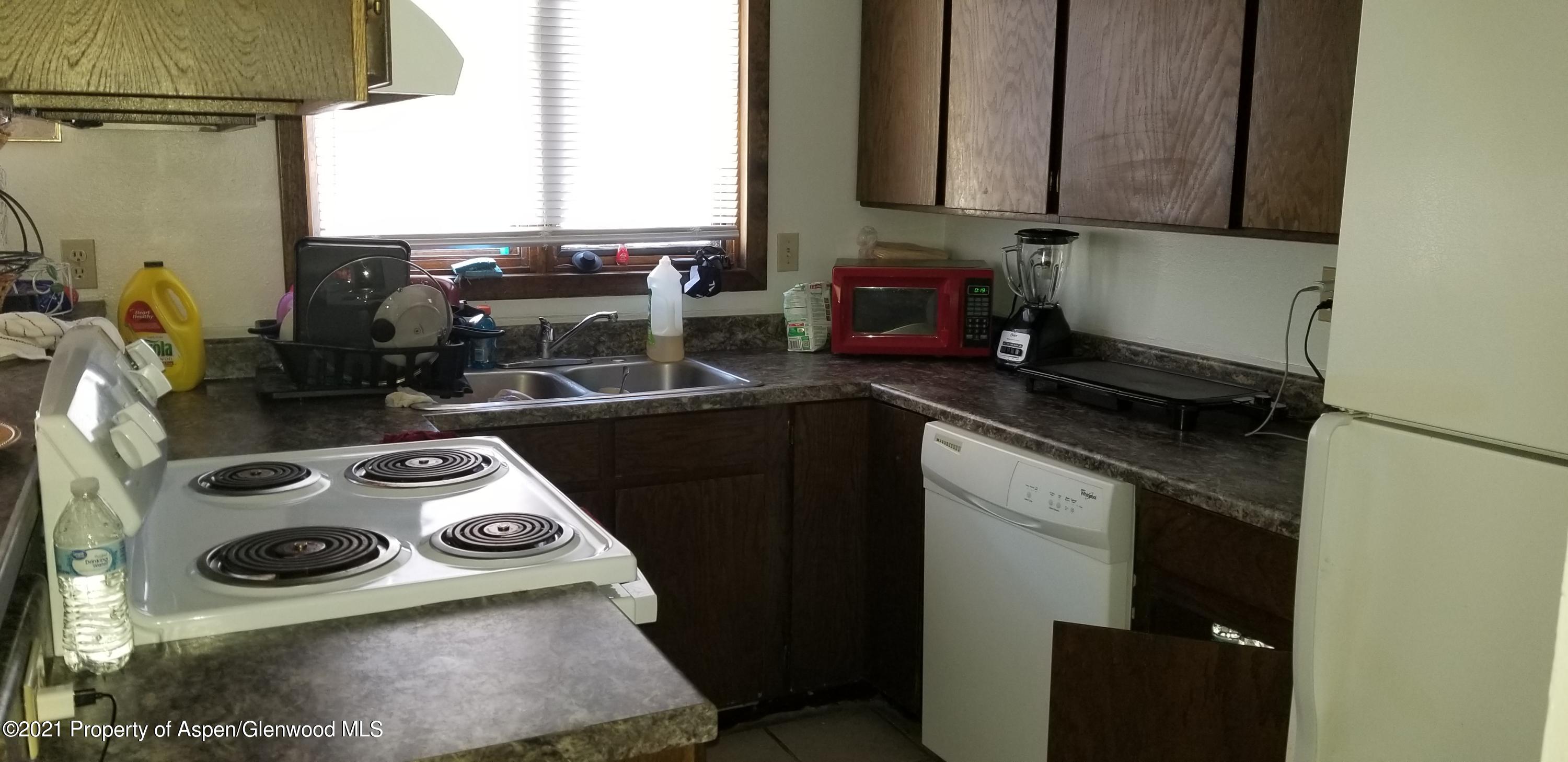 1179 Park Avenue Rifle, CO 81650 - Photo 8 of 16 a kitchen with a stove and a refrigerator