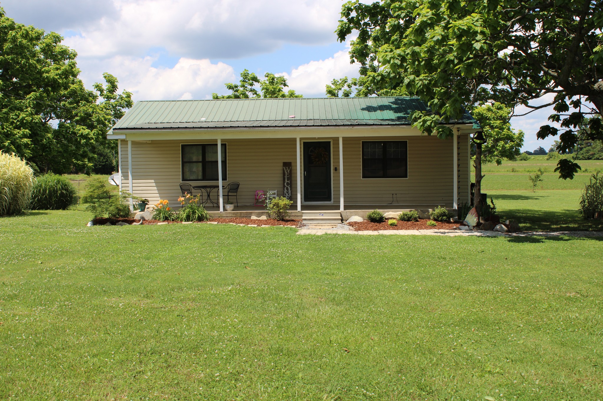25677 Bethel Road Elkmont, AL 35620 - Photo 3 of 28 a front view of house with outdoor seating and green space