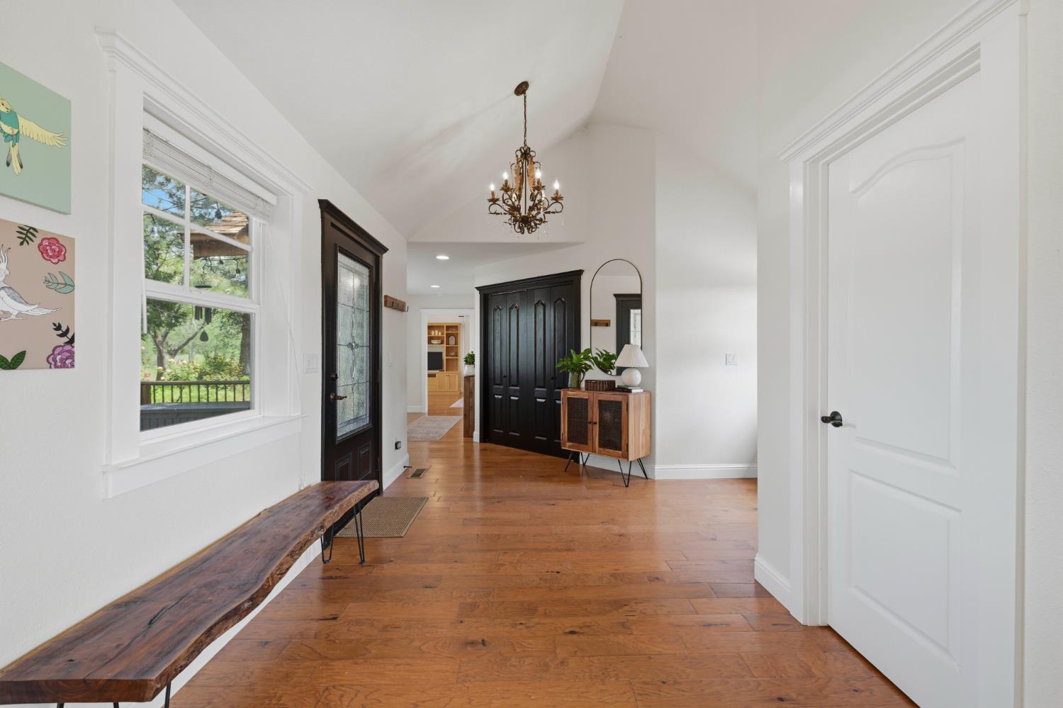 10120 Shenandoah Road Plymouth, CA 95669 - Photo 55 of 86 a hallway with a window and a chandelier