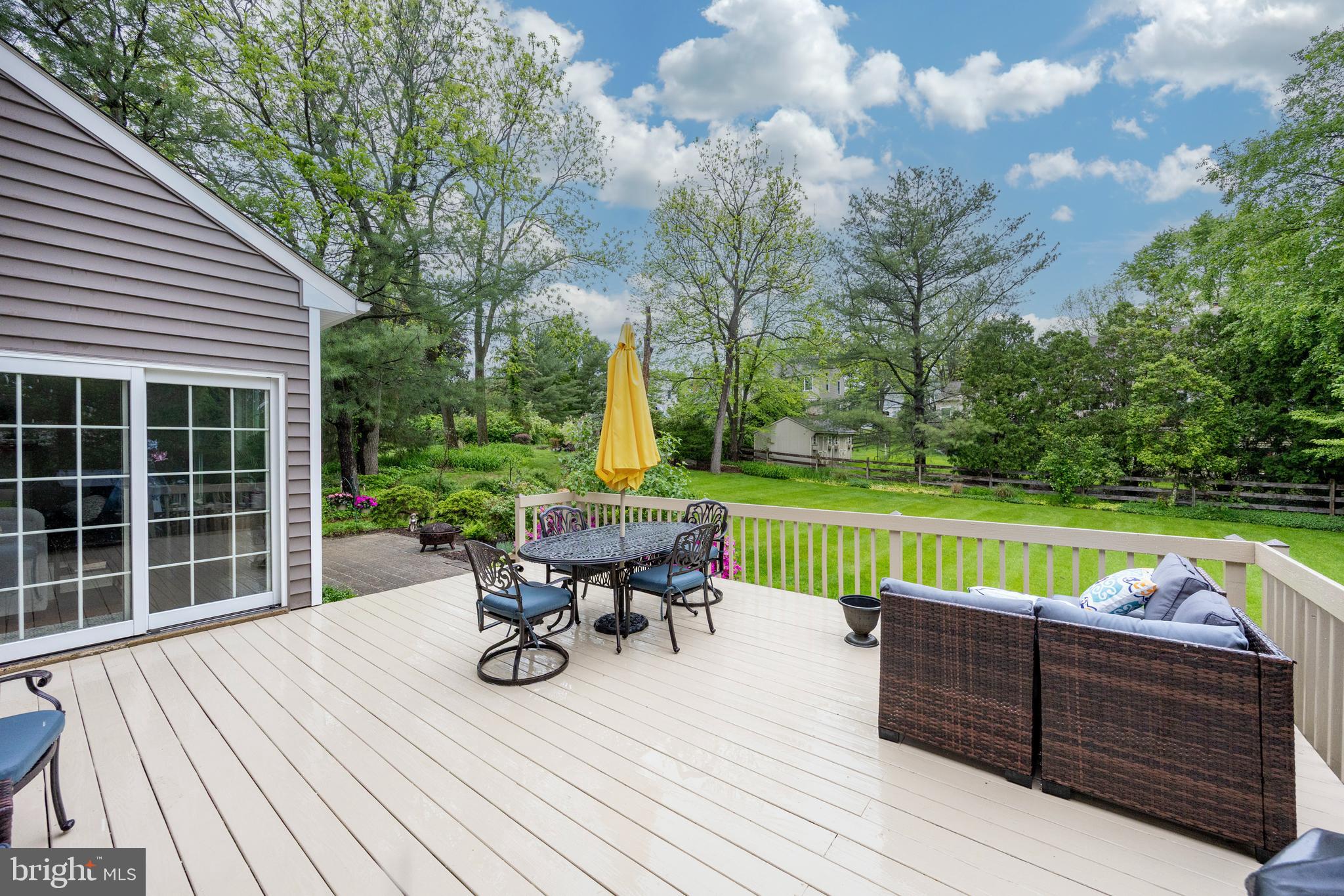 211 Ravenwood Road Exton, PA 19341 - Photo 25 of 44 Fam Rm Sliders to deck, stepdown hardscaped patio