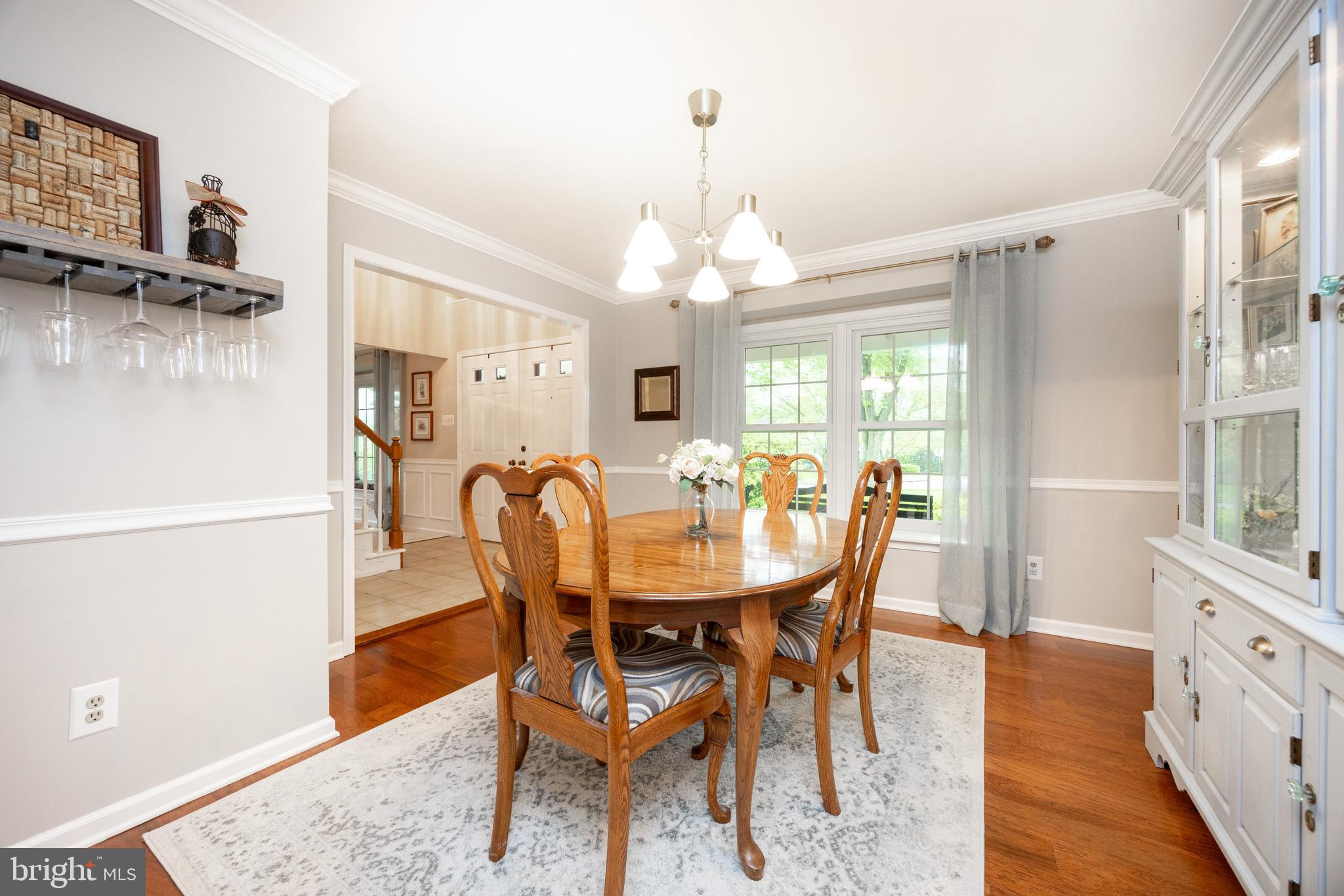 211 Ravenwood Road Exton, PA 19341 - Photo 7 of 44 Dining Room in front w/ beaming Hardwood Flooring