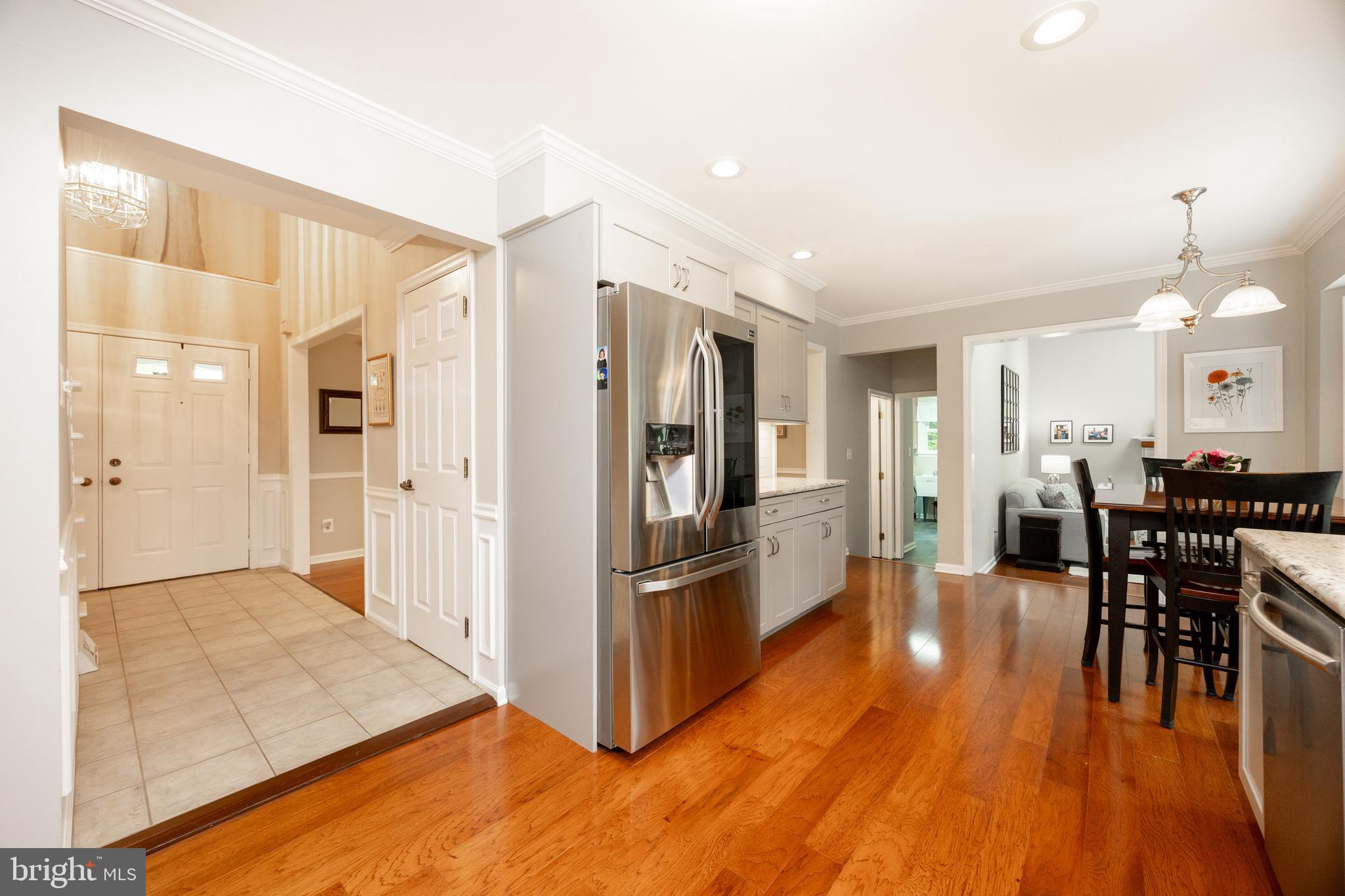 211 Ravenwood Road Exton, PA 19341 - Photo 8 of 44 Down Center Hall to Kitchen w/ Newer Hardwood Flrs