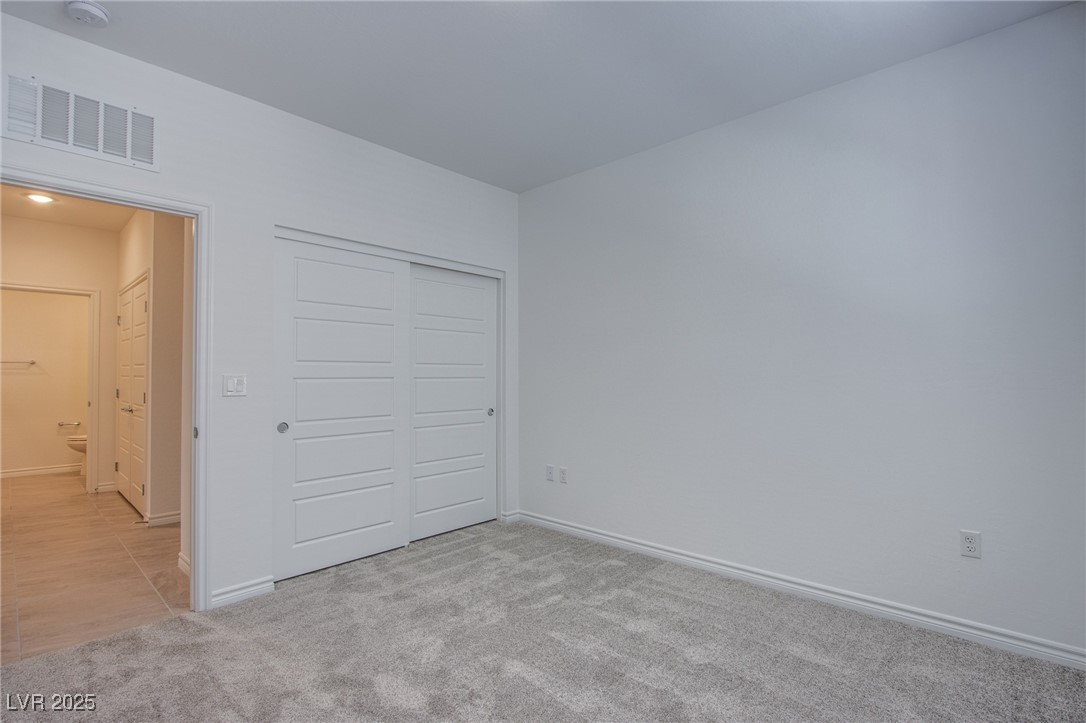 2555 Hampton Road, Unit 11201 Henderson, NV 89052 - Photo 13 of 36 Unfurnished bedroom with carpet and a closet