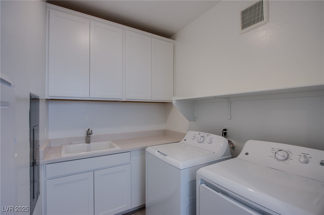 2555 Hampton Road, Unit 11201 Henderson, NV 89052 - Photo 16 of 36 Washroom with washing machine and clothes dryer and cabinet space