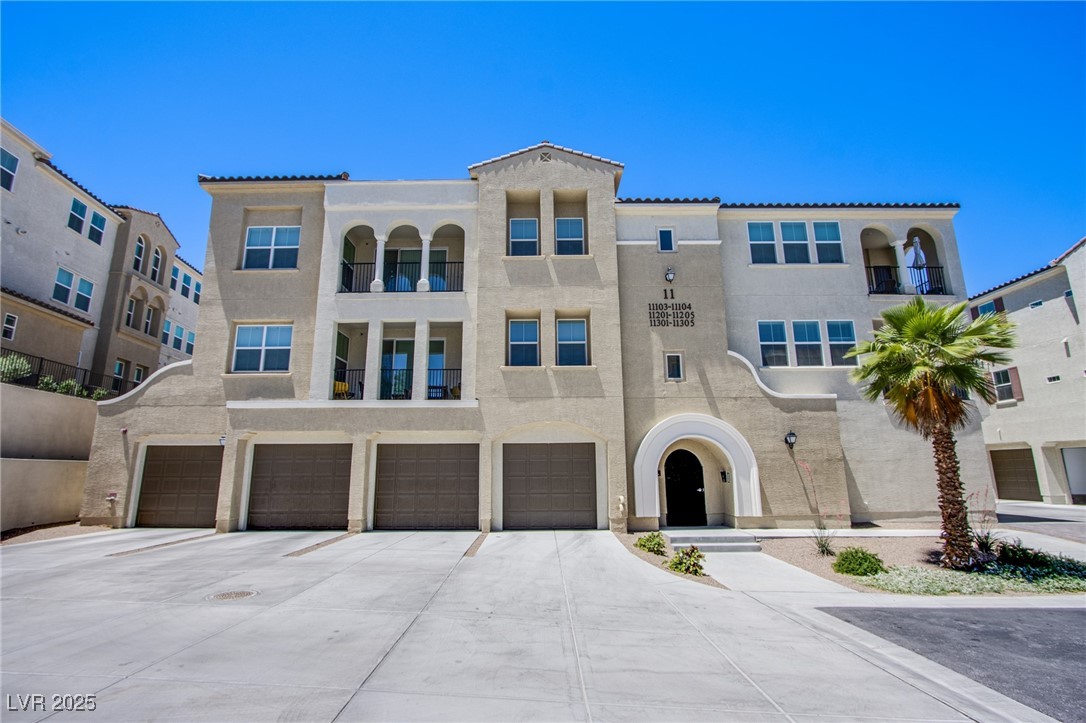 2555 Hampton Road, Unit 11201 Henderson, NV 89052 - Photo 22 of 36 View of front of home featuring driveway, stucco siding, and a garage