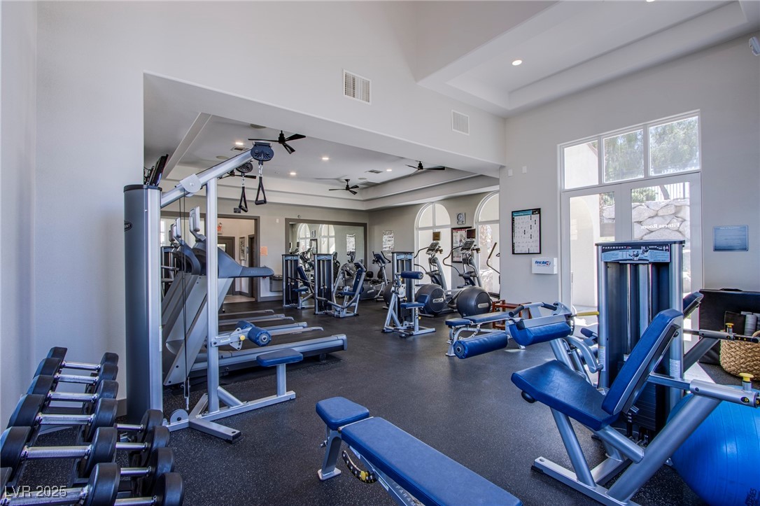 2555 Hampton Road, Unit 11201 Henderson, NV 89052 - Photo 24 of 36 Gym featuring a ceiling fan, a towering ceiling, recessed lighting, and a tray ceiling