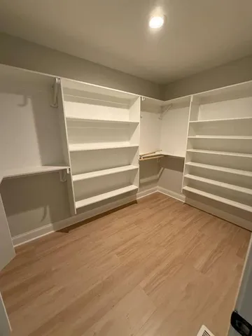 an empty room with a empty space and windows