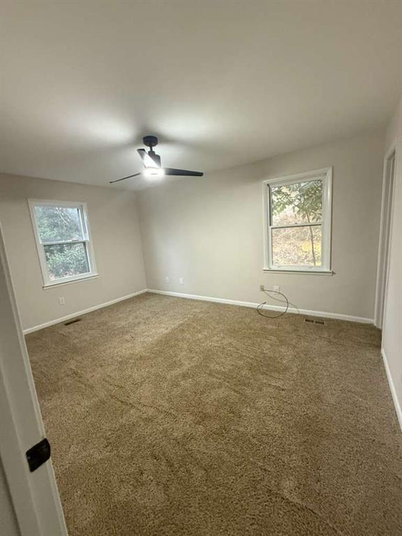110 Foxfire Drive Warner Robins, GA 31093 - Photo 16 of 27 en empty room with windows and ceiling fan view