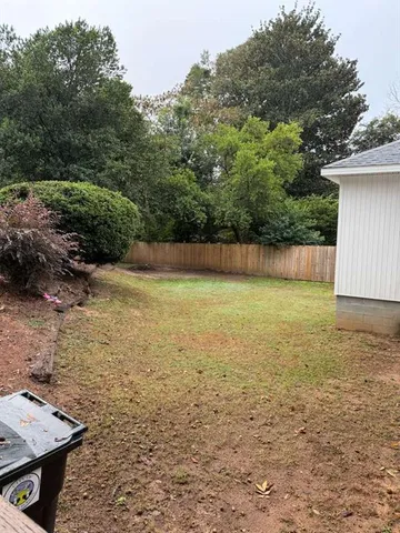a white house that has a tree in front of it