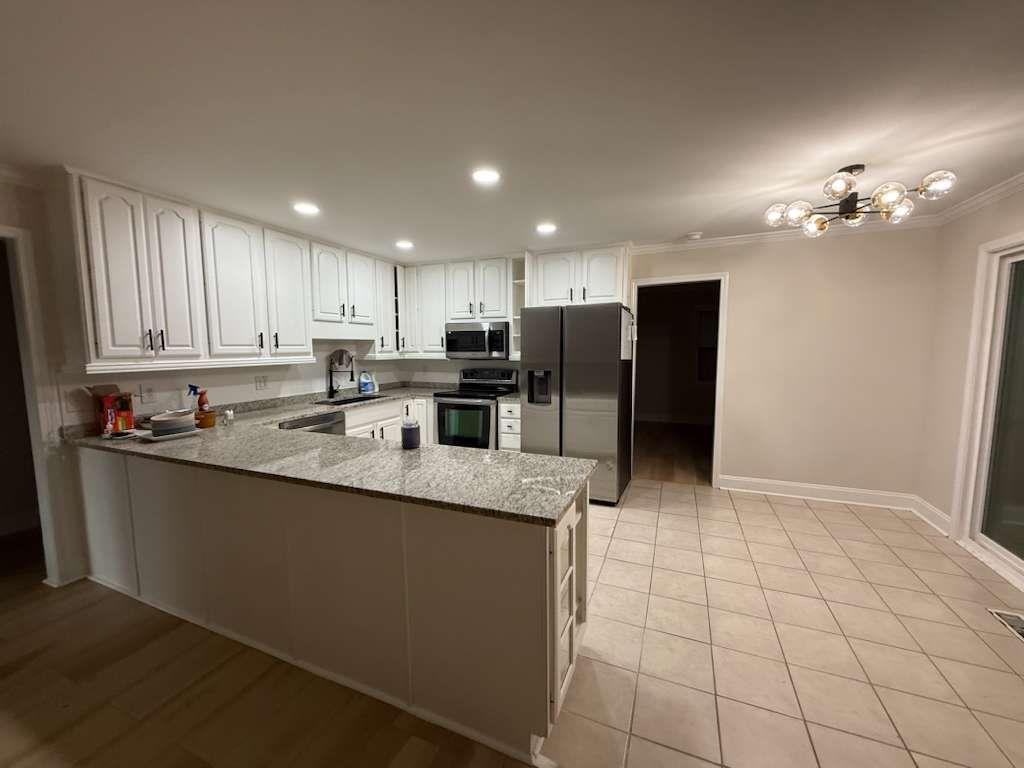 110 Foxfire Drive Warner Robins, GA 31093 - Photo 5 of 27 a kitchen with stainless steel appliances granite countertop a refrigerator a sink a stove a microwave and island