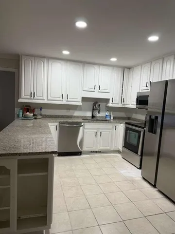 a kitchen with a sink a microwave and cabinets