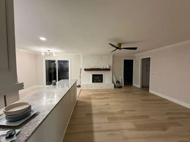 a view of a kitchen with a sink and a fireplace
