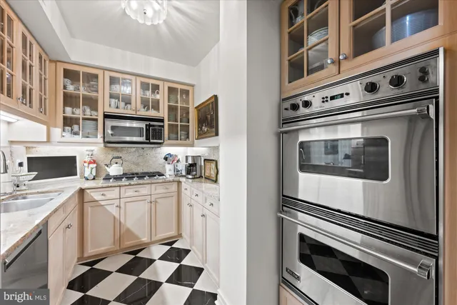 a kitchen with stainless steel appliances granite countertop a stove and a sink