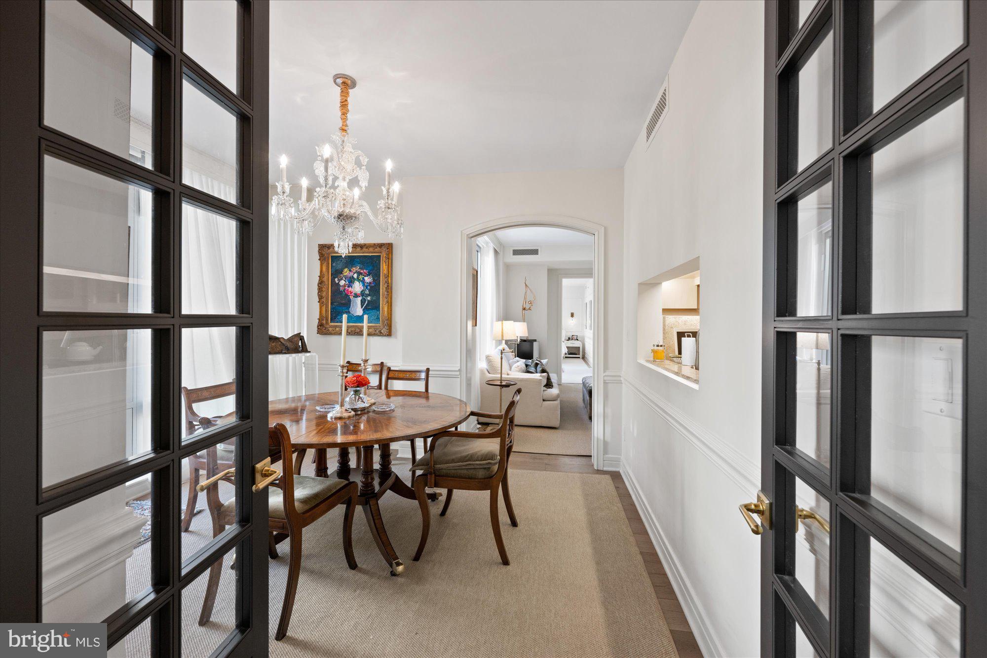 1155 23rd Street Northwest, Unit 7G Washington, DC 20037 - Photo 12 of 38 a view of a dining room with furniture and a chandelier