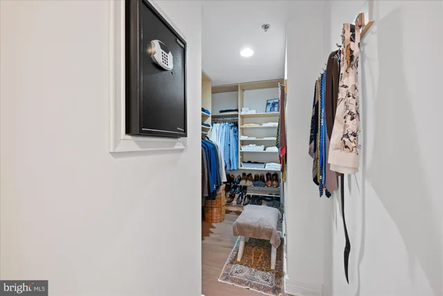 a view of walk in closet with clothes and shoes
