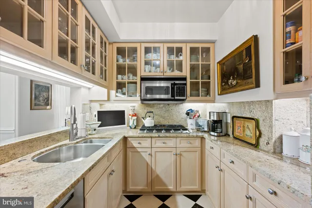 a kitchen with stainless steel appliances granite countertop a sink stove and cabinets