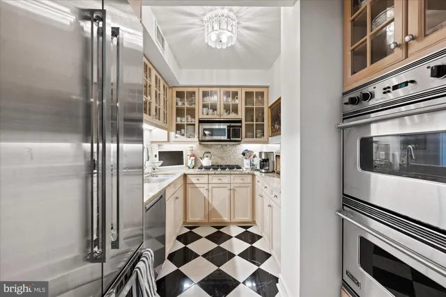 a kitchen with stainless steel appliances a refrigerator and a stove top oven