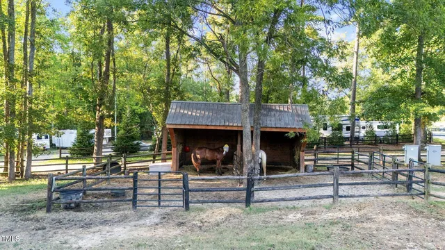 an aerial view of a house with a yard and lake